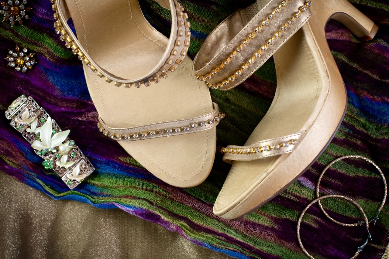 why-choose-us Showcase of bejeweled sandals and accessories on a vibrant scarf. Perfect for fashion and elegance.